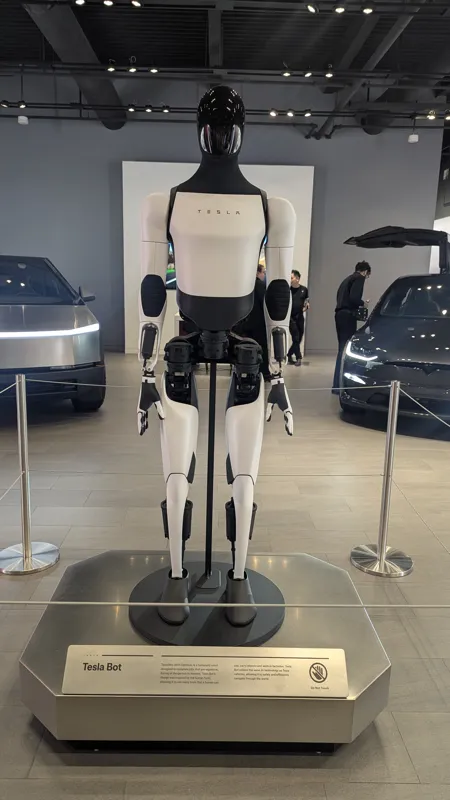Tesla Optimus Gen 2 humanoid robot in a home robotics comparison, representing the ambitious future many buyers still see as too much robot for today's homes